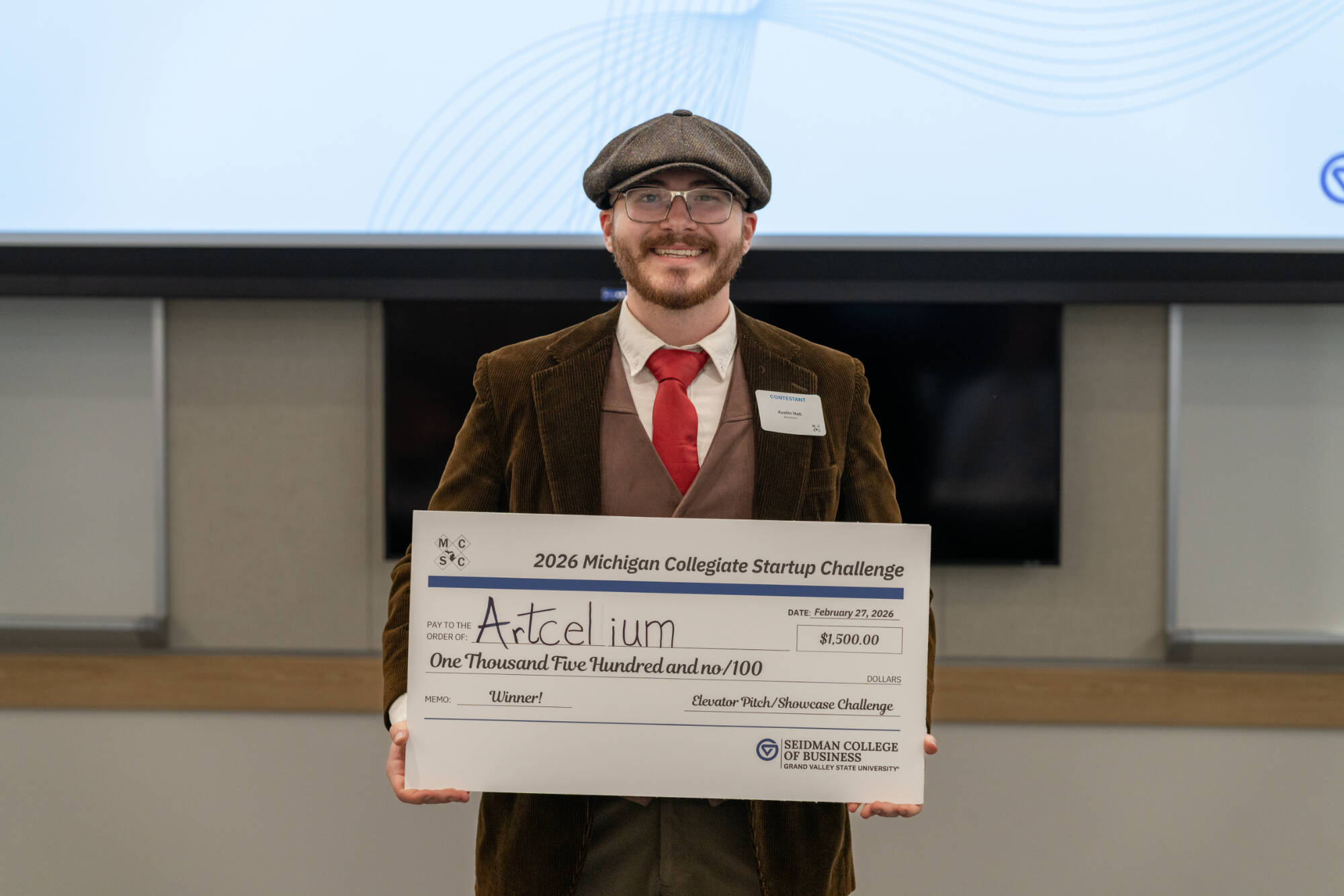Representative of Artcelium with their prize check